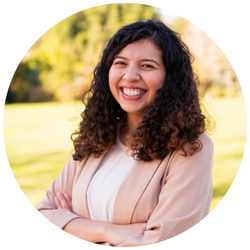 photo of Gabriella Carrion, a UCR student with dark curly hair, smiling at the camera