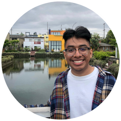 Photo of Christian Lopez, a UCR student with short dark hair who is smiling at the camera